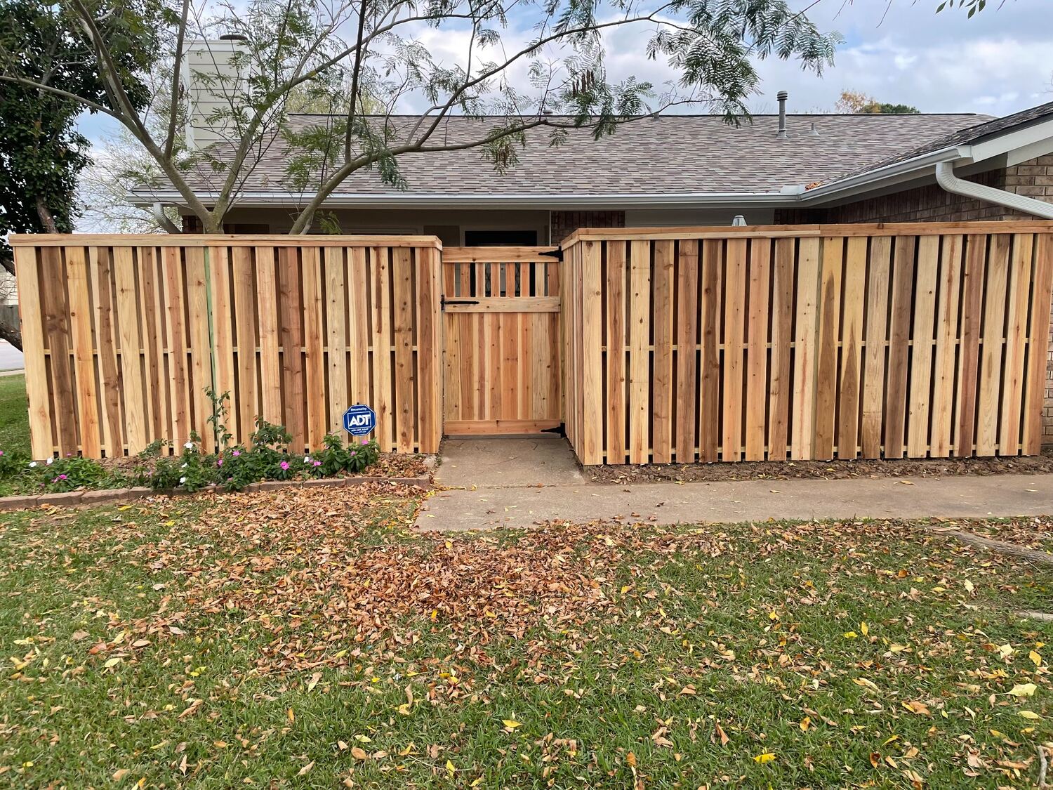Custom cedar fence with a matching walkway gate